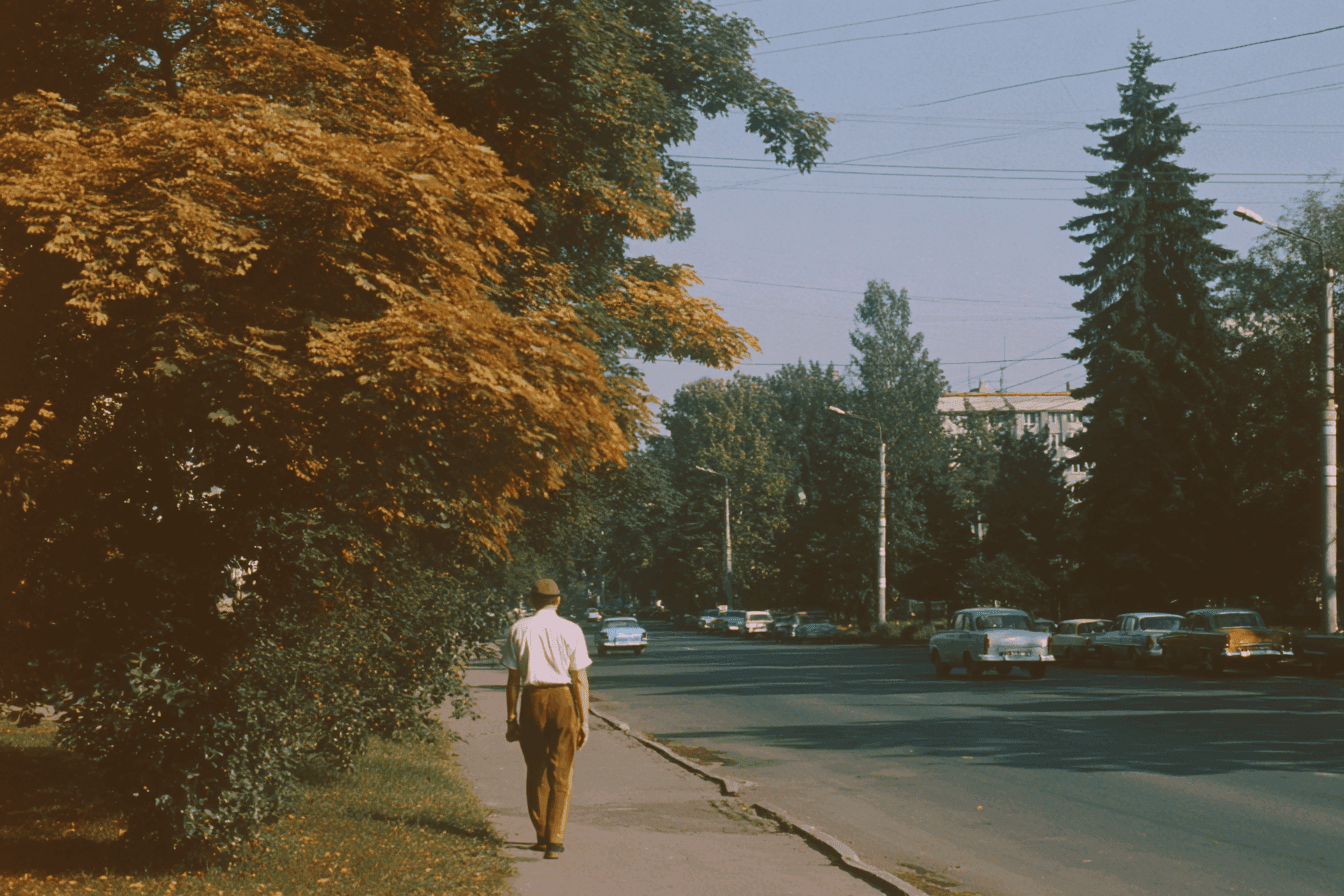 Man Walking Under Autumn Trees